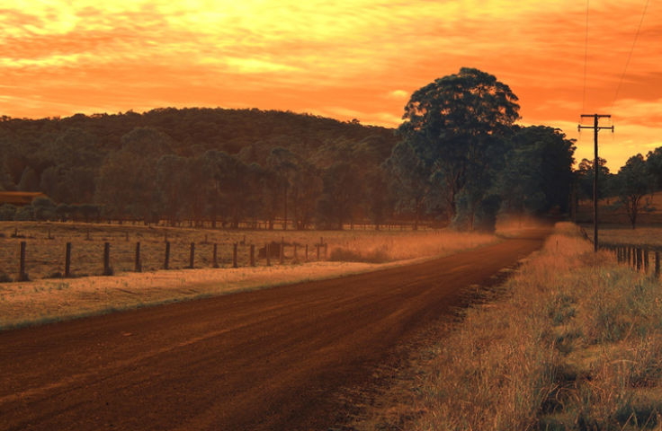 Image of a beautiful regional landscape during sunset, under a bright orange sky.